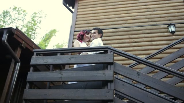 Couple hugging on the stairs and kissing