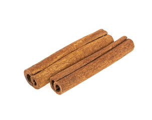 two cinnamon sticks on a white background