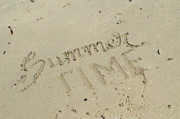 SUMMER TIME hand lettered in sand on beach