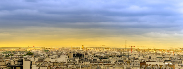 Fototapeta premium Aerial panorama of Paris skyline over roofs at sunset