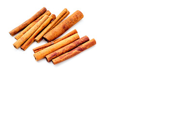 Cinnamon sticks on white background top view copy space. Condiment for mulled wine