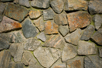 granite wall of stone pieces, background, mosaic