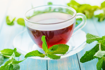 cup of black tea with fresh mint