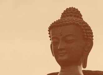 figurine of Buddha against sepia background