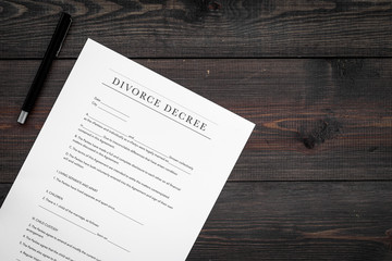 Divorce decree. Document on dark wooden backgroud top view
