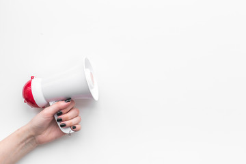 Attract attention concept. Megaphone in hand on white background top view copy space