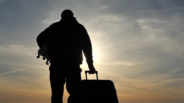 man with suitcase and dog on hands slow motion silhouette distancing