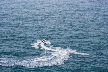 People are playing a jet ski in the sea.Aerial view. Amazing nature background.The color of the water and beautifully bright. Fresh freedom. Adventure day