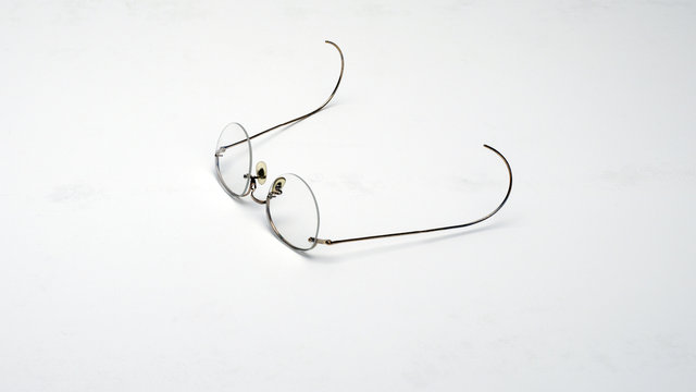 Metal frame eyeglasses on white background