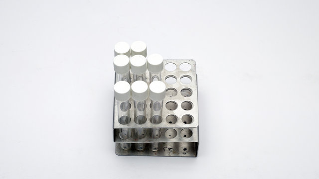 Empty test tubes in old metal tray