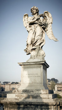 Angel statue atop pedestal