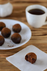 Chocolate candy on a wooden table with a cup of coffee
