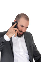 Smiling man with beard on the cell phone