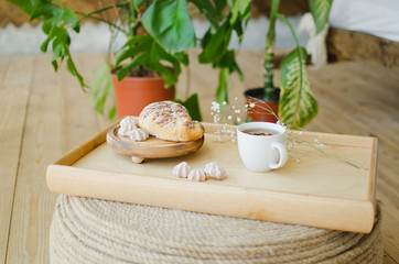 Breakfast in bed, fragrant tea and croissants for breakfast