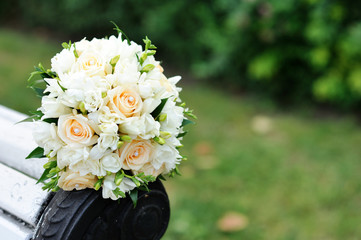 Bouquet of a bride on a white bench. Beautiful wedding bouquet. 