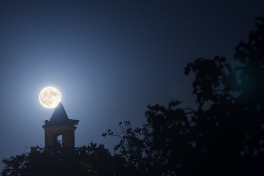 Bell tower of church with super moon