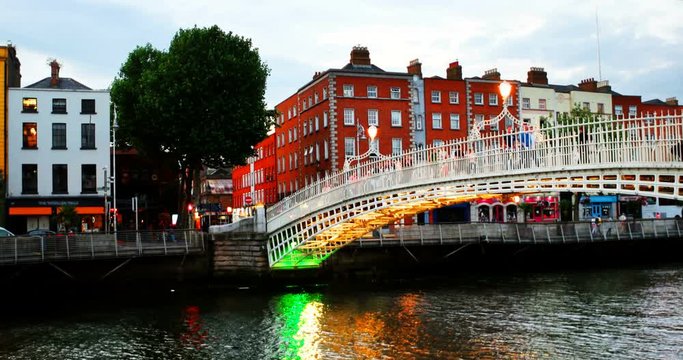 Dublin, Ireland. People going by famous Ha Penny Bridge in Dublin, Ireland during the evening