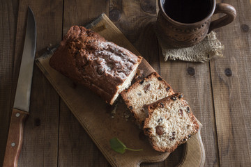 sliced long baked cake with raisins on top of the board