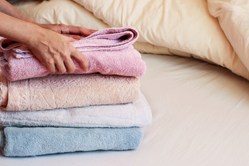 Obraz na płótnie Canvas Colorful pastel towels on a bed