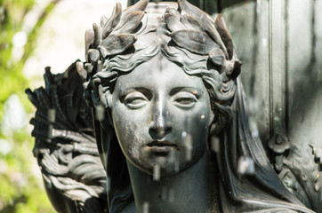 Fototapeta na wymiar Gray Statue of Woman in Berlin, Germany