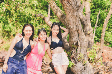 Beautiful woman wearing a swimsuit playing in the beach.