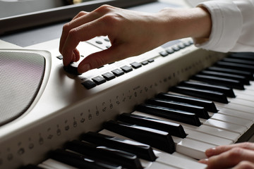 Female hands set up the sequencer, the practice of playing on the keys