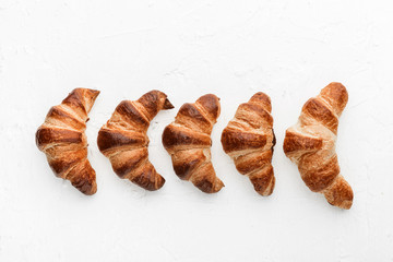 four croissants on a white background