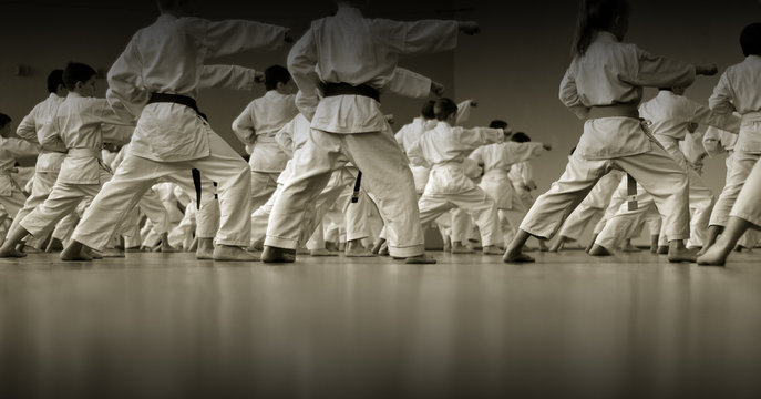Kids training on karate-do. Black and white.