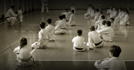 Kids training on karate-do. Black and white.