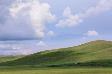 green hills under blue sky