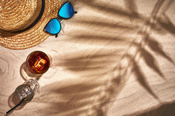 Fototapeta na wymiar Top view of summer accessories on sandy beach