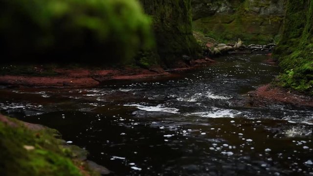 an early morning shot of the devils pulpit gorge in scotland at first light