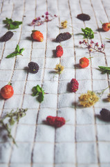 Close-up of mulberry fruit and strawberry, Fresh berry fruit and mint on white fabric.