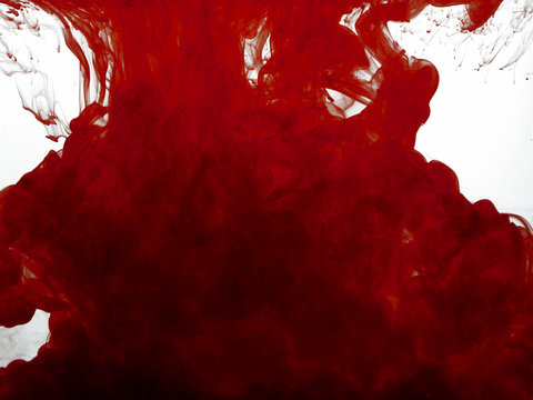 Red color pigment in water on white background