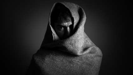 Portrait of man in fabric. Black and white.