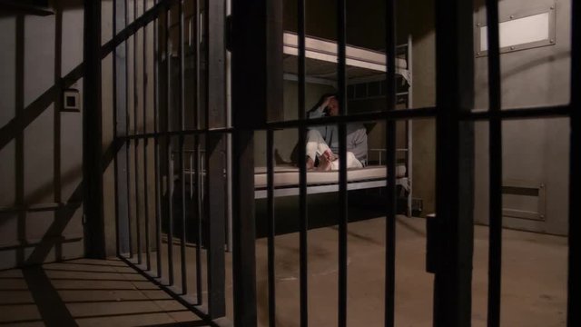 SAD MAN IN HIS JAIL CELL, MODEL RELEASE