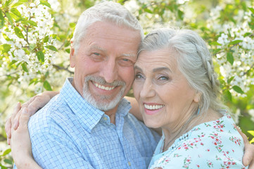 couple  hugging in  blooming garden 