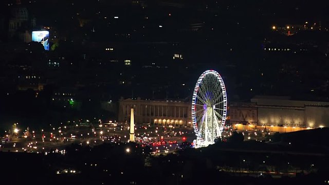 Aerial night view timelapse of traffic in Paris, the famos ferris wheel of the Place de la Concorde, France