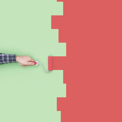 Decorator painting a wall with a paint roller © stokkete