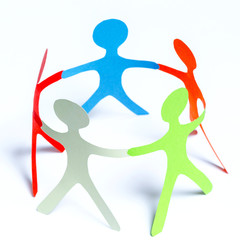 Paper people of different colors standing in a cycle holding hands