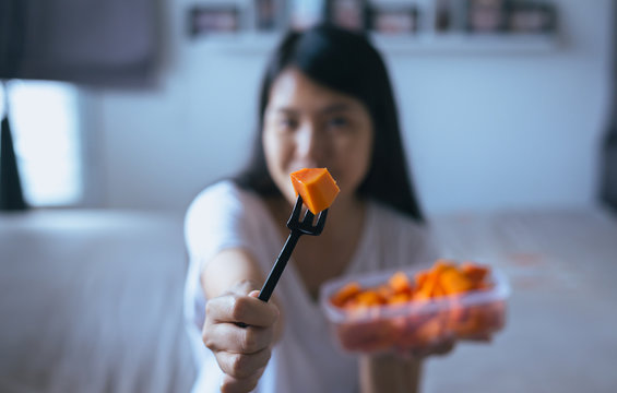 Woman eating fresh fruits papaya slices,Concept healthy food