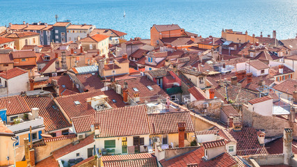 Old houses with red roofs in Piran town on Adriatic sea, one of major tourist attractions in Slovenia, Europe.