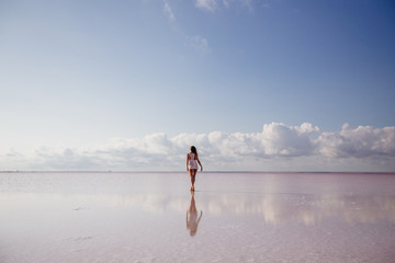 Beautiful girl on a pink lake.