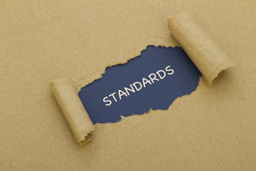 Standards written under torn paper.