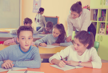 Teacher and schoolkids during lesson