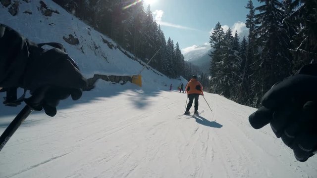 Winter pov of people skiing on slope of famous ski resort Bansko