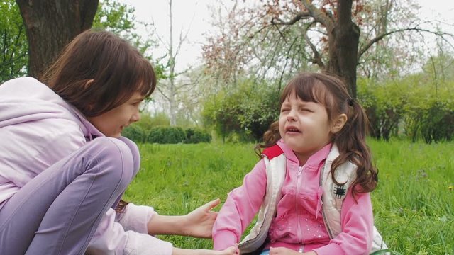 Injury of the child. The little girl feels sorry for sister.