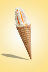 Vanilla ice cream with jam in a waffle cone. Bright color, summer mood.