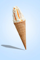 Vanilla ice cream with jam in a waffle cone. Bright color, summer mood.