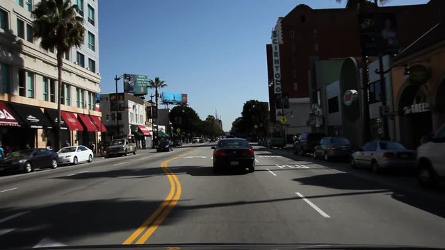 Driving on Hollywood Boulevard, past Guinness Museum, old Christie Hotel, and Egyptian Theater